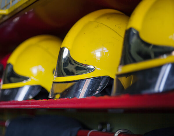 A closeup shot of a row of protective yellow helmets