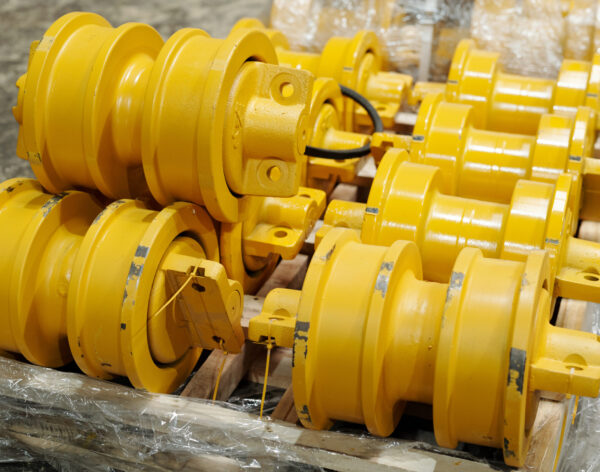 Group of yellow metal spare parts for modern industrial or construction machines made in contemporary plant of heavy industry