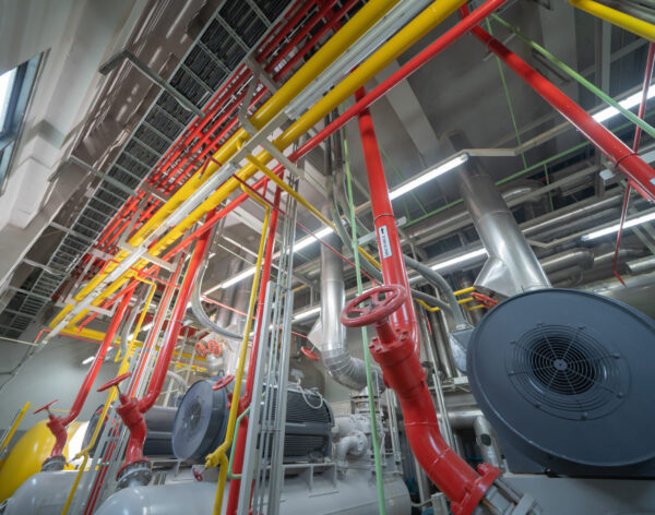 Ceiling of Industry factory. Chiller tower or cooling tower in building. System work machine. Condenser Water Supply and return pipe lines. Ventilation compressor. Water system in workshop.