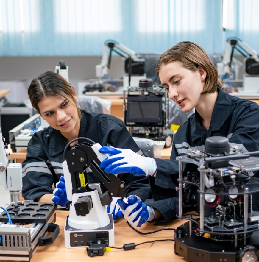 Female Engineer Man working at industrial robot in factory industrial. robotic and manufacturing